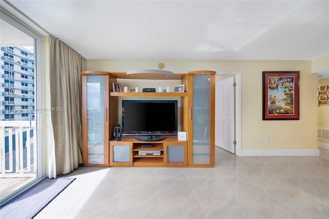 unfurnished living room featuring expansive windows and light tile patterned flooring