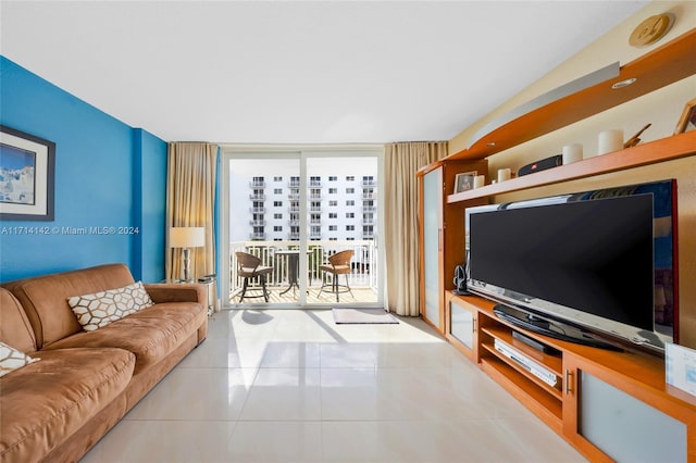 living room featuring a wall of windows and light tile patterned flooring