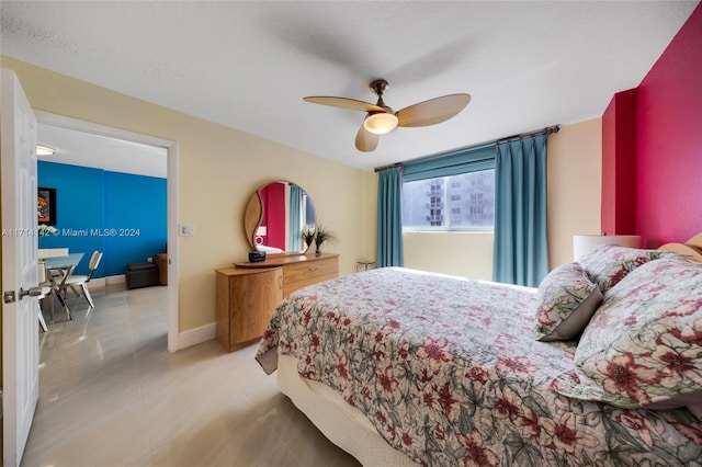 tiled bedroom featuring ceiling fan