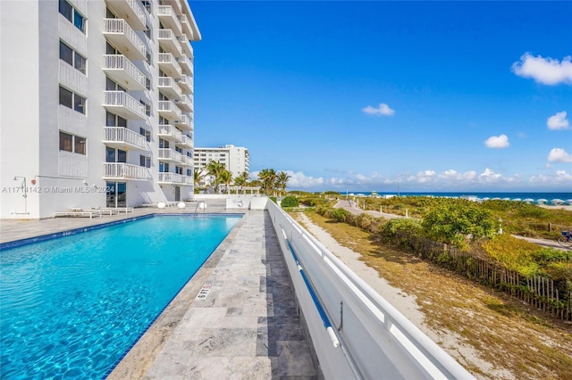 view of pool featuring a water view