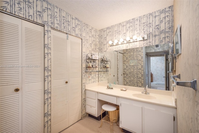 bathroom with vanity and a textured ceiling