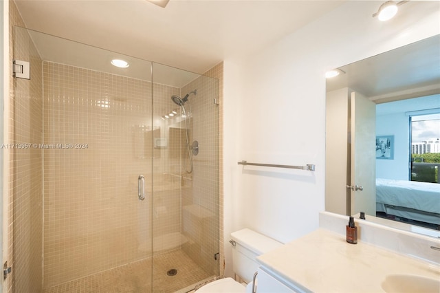 bathroom with vanity, an enclosed shower, and toilet