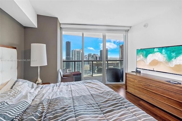 bedroom featuring dark hardwood / wood-style flooring and floor to ceiling windows