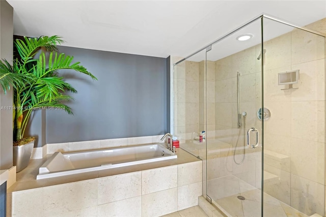 bathroom featuring shower with separate bathtub