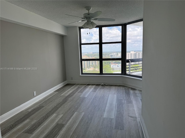 3530 Mystic Pointe Dr Unit 2602, Aventura, FL 33180 - spare room with a ceiling fan, a textured ceiling, and dark wood-style floors