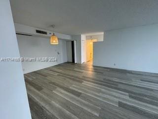 empty room featuring dark wood-type flooring