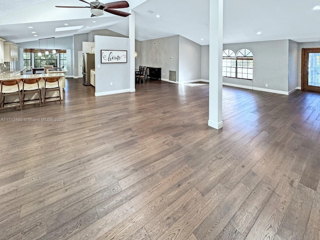 unfurnished living room with lofted ceiling, hardwood / wood-style floors, and ceiling fan