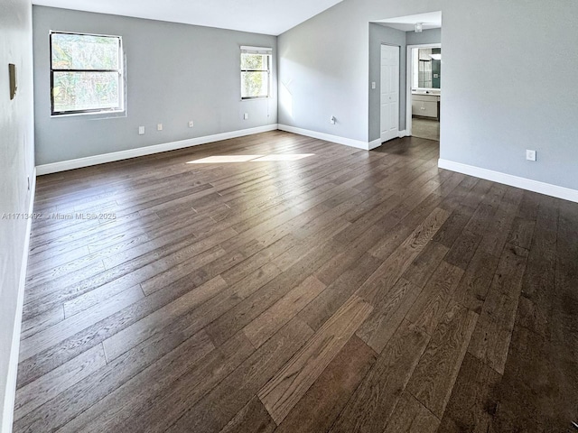 spare room with dark hardwood / wood-style flooring