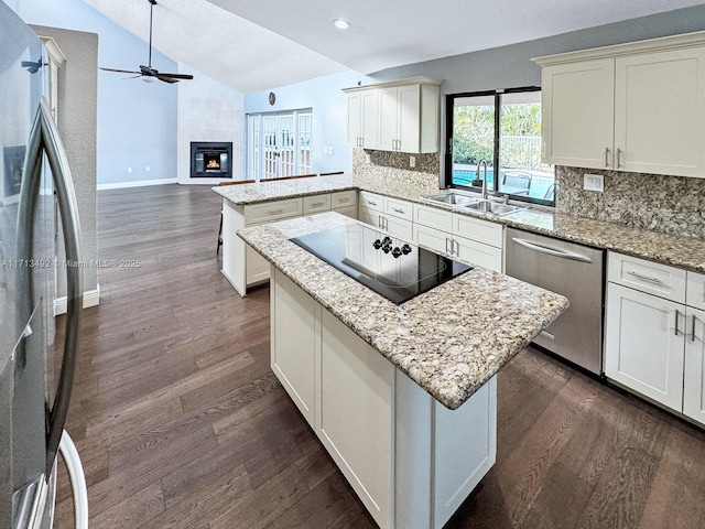 kitchen featuring tasteful backsplash, sink, vaulted ceiling, and stainless steel appliances