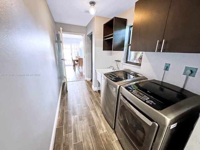 laundry room featuring cabinets and independent washer and dryer