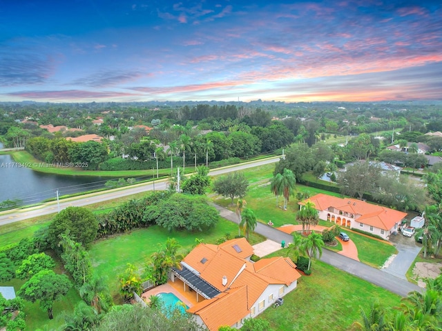 aerial view at dusk with a water view