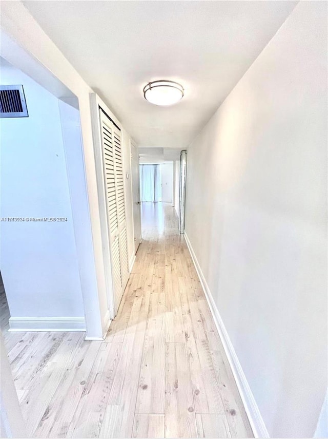 corridor with light hardwood / wood-style flooring