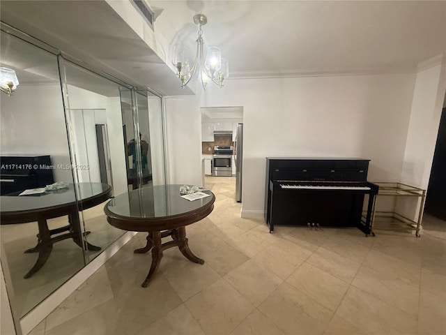 living area with ornamental molding and a chandelier