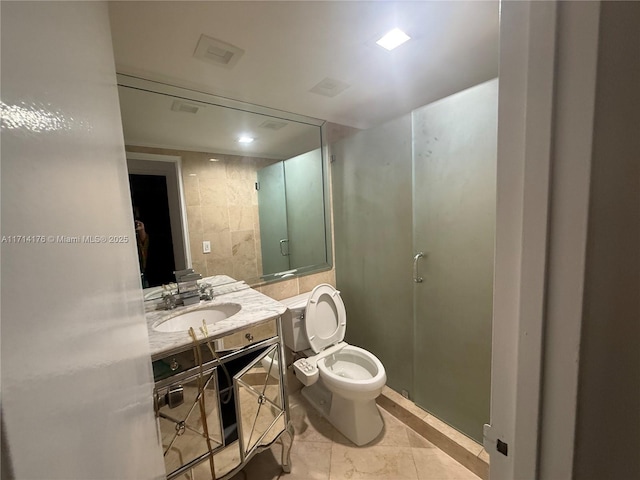 bathroom with tile patterned flooring, vanity, toilet, and walk in shower