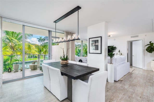 1201 20th St Unit 304, Miami Beach, FL 33139 - dining space featuring light wood-type flooring and a wall of windows