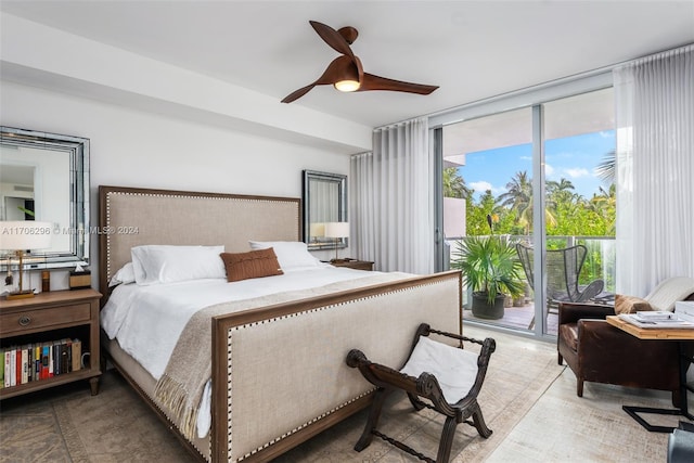 bedroom featuring access to exterior, ceiling fan, and a wall of windows