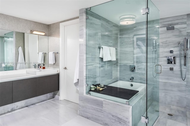 bathroom with vanity, separate shower and tub, and tile walls