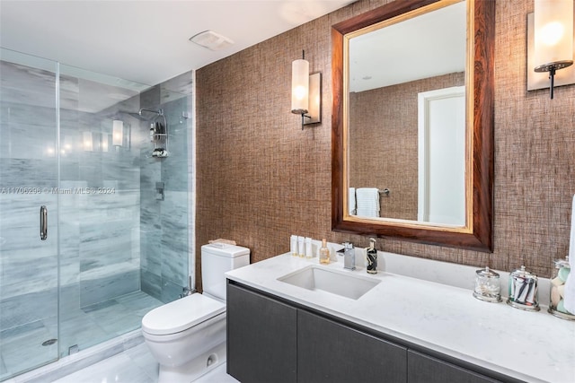 bathroom featuring walk in shower, vanity, and toilet