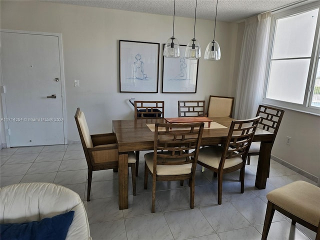 dining space with a textured ceiling