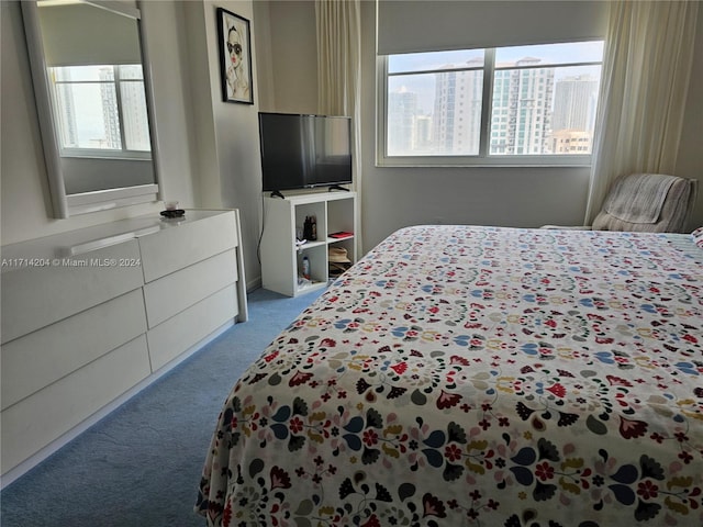 bedroom featuring light colored carpet and multiple windows