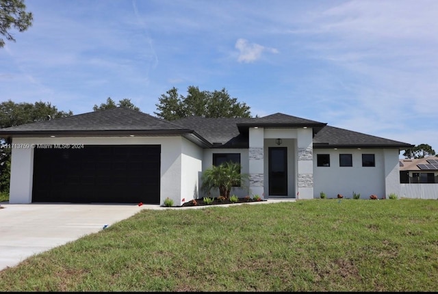 prairie-style house featuring a front yard and a garage