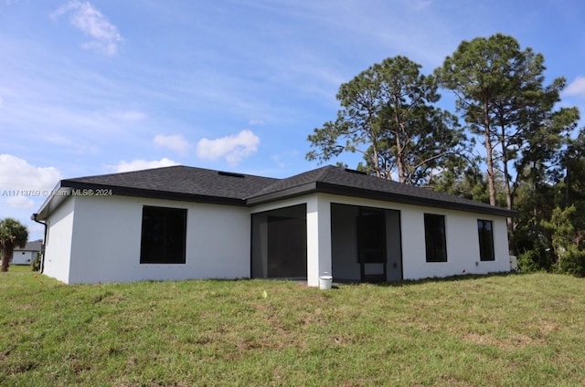 rear view of property with a yard