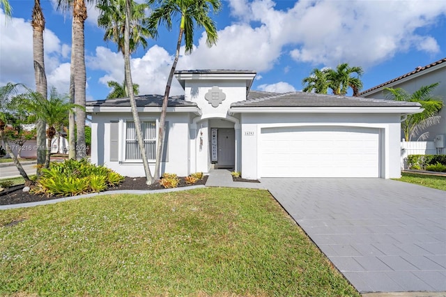 view of front of home with a front yard and a garage