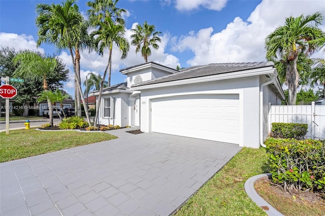 view of front of property with a garage and a front lawn