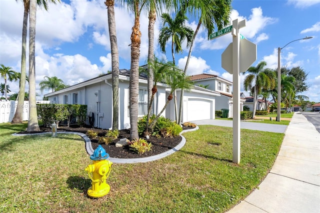 view of front of property featuring a front lawn and a garage