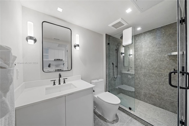 bathroom with tile patterned floors, vanity, toilet, and an enclosed shower