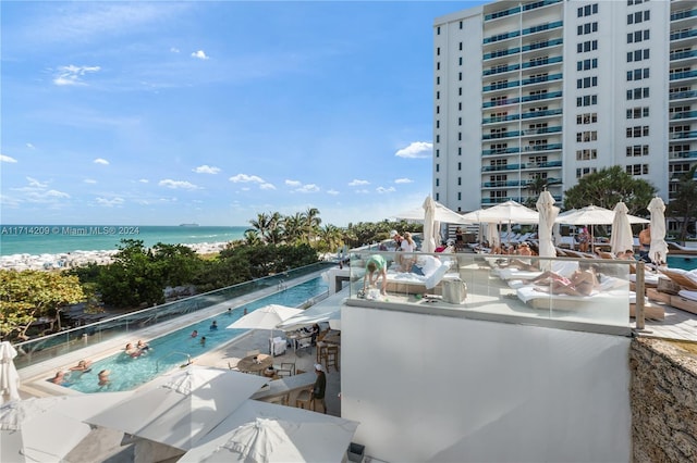 view of swimming pool featuring a water view