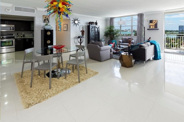 dining space with light tile patterned floors, visible vents, and crown molding