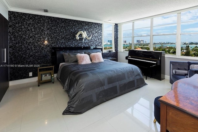 bedroom featuring a view of city, crown molding, a textured ceiling, baseboards, and tile patterned floors