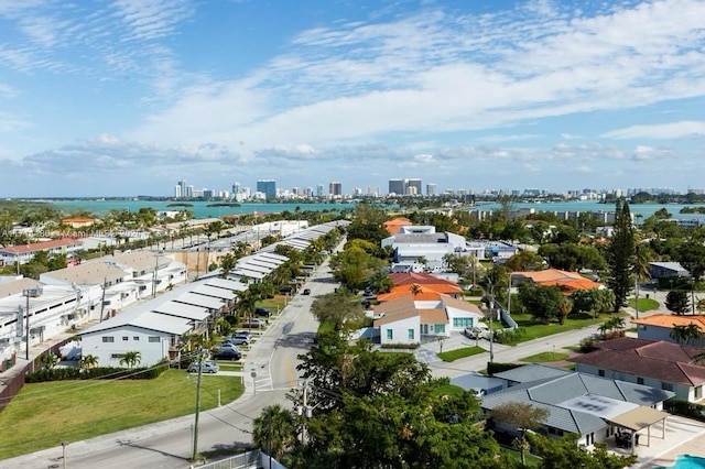 drone / aerial view featuring a water view and a city view