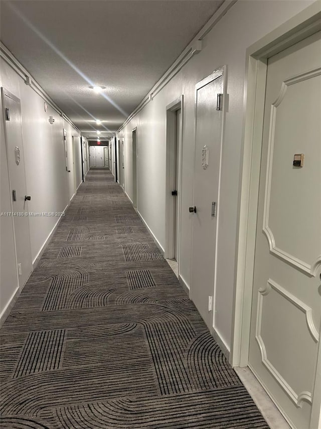 corridor with dark colored carpet