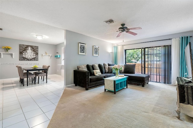 carpeted living room featuring a textured ceiling and ceiling fan