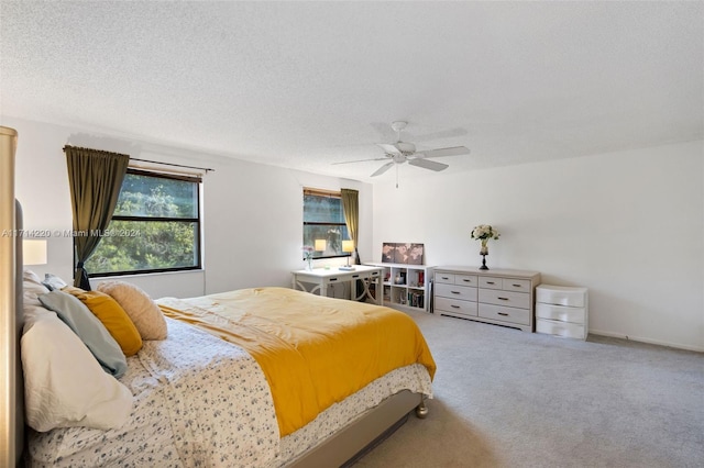 carpeted bedroom with a textured ceiling and ceiling fan