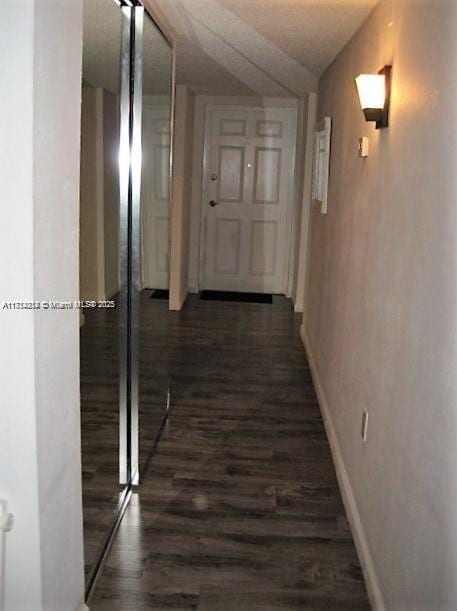 hallway with dark hardwood / wood-style floors