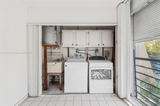 laundry area featuring cabinets, independent washer and dryer, and sink