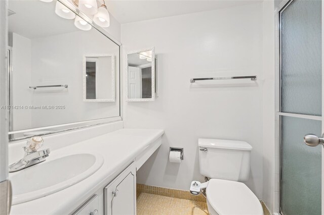 bathroom with vanity, toilet, and walk in shower