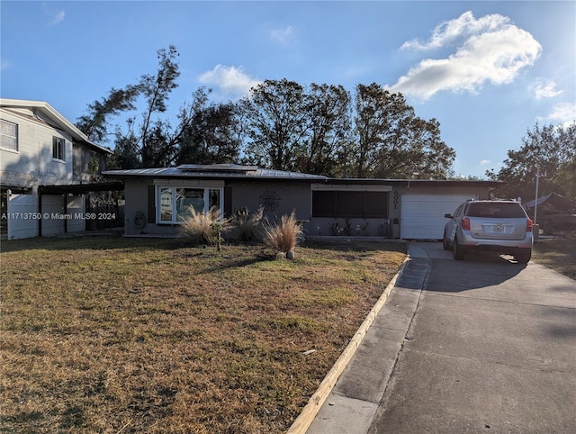 view of front facade with a garage and a front lawn