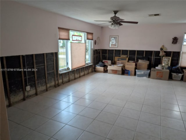 interior space with ceiling fan and light tile patterned floors