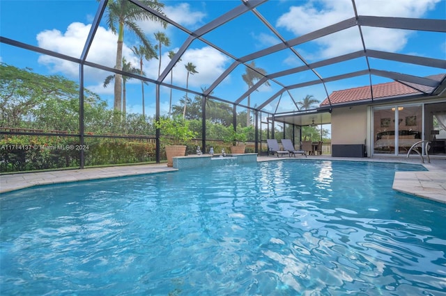 view of swimming pool with a lanai, a patio area, and ceiling fan