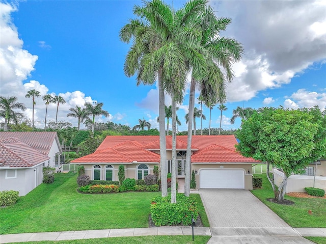 821 E Cypress Pointe Dr E, Pembroke Pines, FL 33027 - mediterranean / spanish-style home featuring a tiled roof, a garage, driveway, and stucco siding