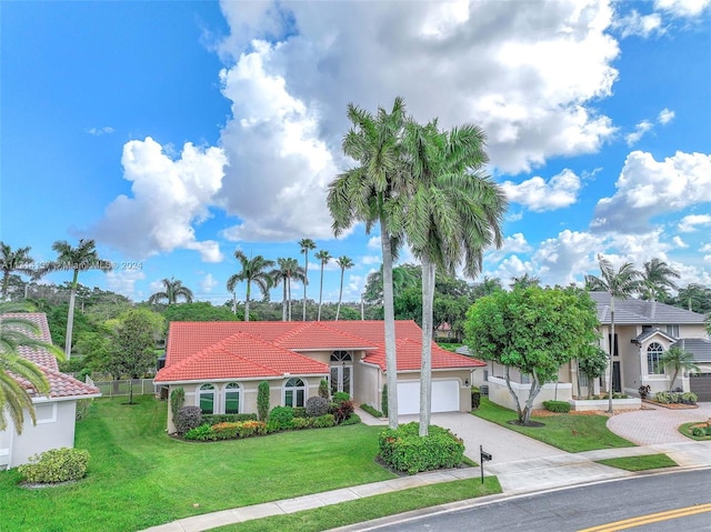 view of front of property with a garage and a front lawn