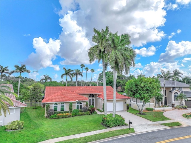 821 E Cypress Pointe Dr E, Pembroke Pines, FL 33027 - mediterranean / spanish house featuring driveway, an attached garage, stucco siding, and a tiled roof