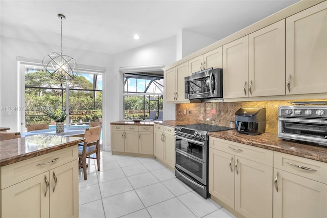 821 E Cypress Pointe Dr E, Pembroke Pines, FL 33027 - kitchen featuring appliances with stainless steel finishes, decorative backsplash, dark stone counters, light tile patterned floors, and pendant lighting
