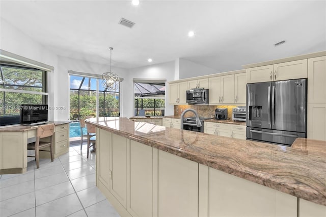 821 E Cypress Pointe Dr E, Pembroke Pines, FL 33027 - kitchen featuring stainless steel appliances, backsplash, light stone countertops, cream cabinetry, and recessed lighting