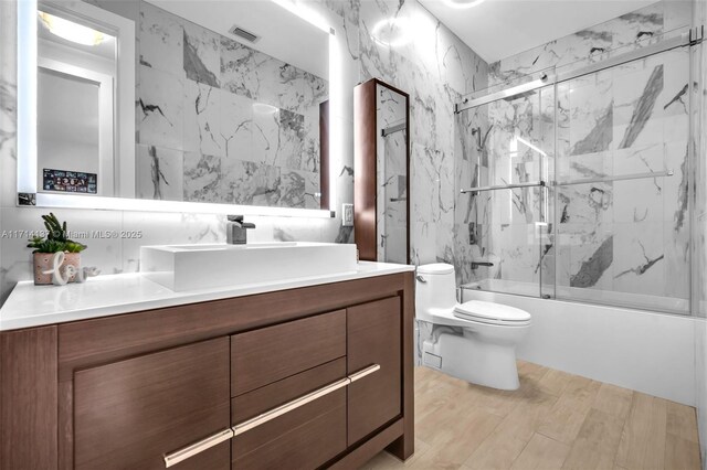 821 E Cypress Pointe Dr E, Pembroke Pines, FL 33027 - full bath featuring enclosed tub / shower combo, vanity, and wood finished floors