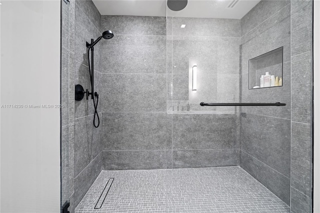 bathroom with tiled shower